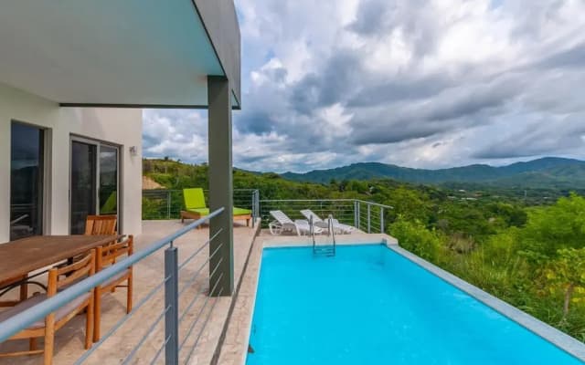 Modern Hillside Home with Sleek Interiors and Panoramic Poolside Views